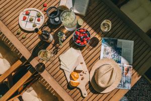 a table with food and drinks and a hat on it at Róka Porta in Szentkirályszabadja