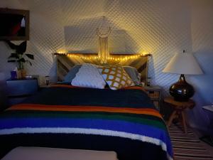 a bedroom with a large bed with lights on it at Star Garden Az in Valle