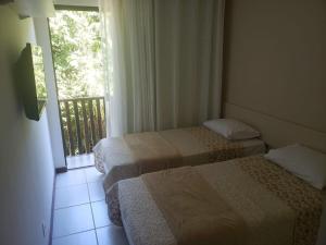 Giường trong phòng chung tại 2 quartos - Village em Condomínio - Itacimirim Beach +40 ảnh
