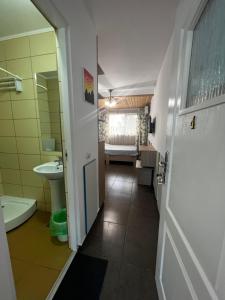 a bathroom with a toilet and a sink at Vila Andra in Eforie Nord