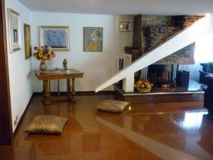 a living room with a staircase and a fireplace at B&B Cà d'Artisti in Caorle