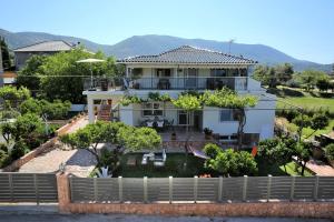 a large white house with trees in front of it at "Elegant & Quiet House" in Igoumenitsa