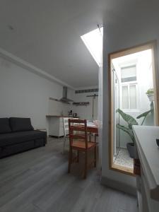 a living room with a table and a mirror at Casa Reyes in Rota