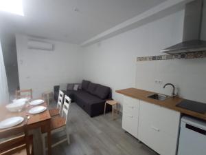 a kitchen and living room with a couch and a table at Casa Reyes in Rota +14 photos
