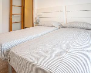 A bed or beds in a room at Appartamento Corsaro