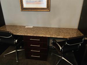 a desk in a room with chairs and a picture on the wall at Halfway House Hotel in Kimberley