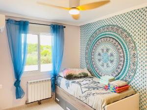 a bedroom with a bed with a large wall art at Casa Azure in Gran Alacant +34 photos