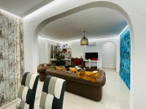 a living room with a brown couch in a room at Casa Azure in Gran Alacant