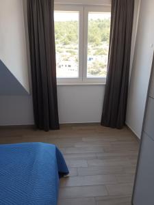 Postel nebo postele na pokoji v ubytování Apartment Teuta
