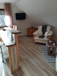 a living room with a couch and a table at Ferienwohnung Waldblick in Hallenberg