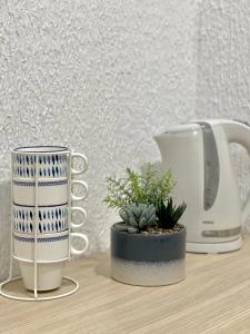 a coffee maker and a cup on a table at Monte Perla Residence in Sveti Stefan