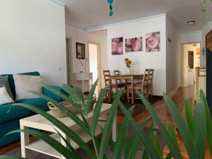 a living room with a blue couch and a table at La Casita de mi Alma - Das Haus meiner Seele (Tegueste) in Tegueste