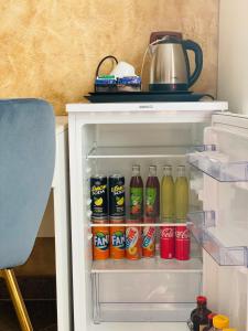 an open refrigerator filled with lots of drinks at Armonia B&B in Aquino