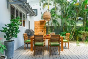 a wooden table and chairs on a deck at Peace Villa Santa Teresa - Walking distance to the beach in Santa Teresa Beach +52 photos
