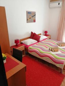 a bedroom with two beds and a table and a desk at Apartment Olimp Ulcinj in Ulcinj