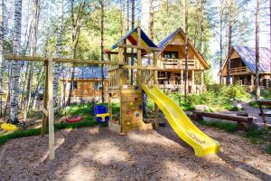 a playground in front of a log cabin at Korobok-Khutorok in Korobitsyno