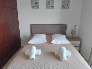 a bedroom with a bed with two white pillows at Salt Lake Sunset Tigaki in Marmari