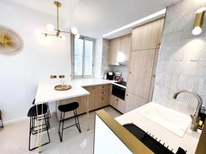 a kitchen with a white counter and a sink at La LOLA APARTMENT in Cannes