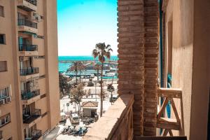 a view of the beach from a building with buildings at Apartamento Puerto Playa, Fuengirola centro in Fuengirola