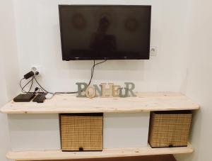 a tv sitting on top of a wooden table at Studio La ciotat Les Anges du Vieux Port in La Ciotat