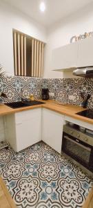 a kitchen with a counter top with a patterned floor at Studio La ciotat Les Anges du Vieux Port in La Ciotat