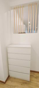 a white dresser in a corner of a room at Studio La ciotat Les Anges du Vieux Port in La Ciotat