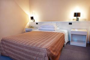 Postel nebo postele na pokoji v ubytování Hotel Giovanni