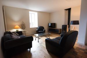 a living room with two couches and a tv at maison bretonne in Guidel