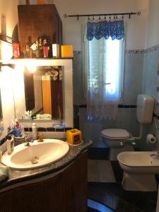 a bathroom with a sink and a toilet and a mirror at Il tuo angolo di paradiso in Monreale +17 photos