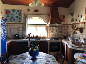 a kitchen with a table with a vase on it at Il tuo angolo di paradiso in Monreale