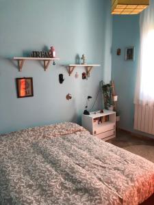a bedroom with a bed and a shelf on the wall at Il tuo angolo di paradiso in Monreale