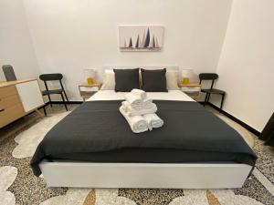 a bedroom with a large bed with towels on it at Albatros in Savona +23 photos