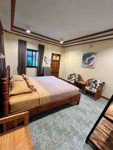 a bedroom with a large bed and a chair at Sandee Bungalow in Thong Nai Pan Noi