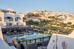 a view of a hotel with a pool and a city at Alleys All-Suite Hotel & Spa in Pirgos