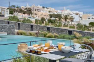 a table with food and drinks on top of a balcony at Alleys All-Suite Hotel & Spa in Pirgos