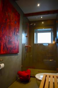 a bathroom with a shower and a toilet and a sink at The Sybilla Apartment - cosy and modern basement apartment in Klaksvík