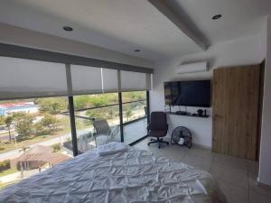 a bedroom with a bed and a flat screen tv at Altamar. Lugar perfecto para ser diamante in Acapulco +17 photos