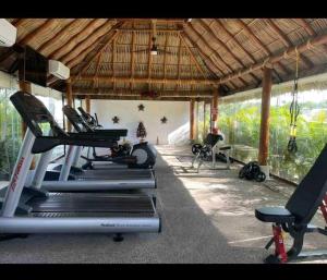 a gym with several tread machines in a building at Altamar. Lugar perfecto para ser diamante in Acapulco