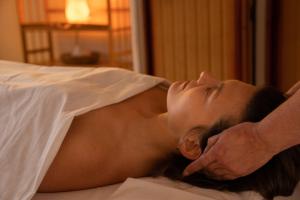 a woman laying on a bed with her head on a sheet at Casa Primal in San José de Maipo