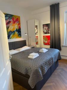a bedroom with a bed with two towels on it at Apartment Factory in Hamburg