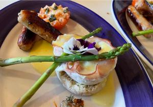 a plate of food with a sandwich and sausage at Quarrystone House B&B in Fernwood