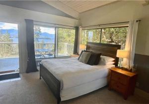 a bedroom with a bed with a view of a balcony at Quarrystone House B&B in Fernwood
