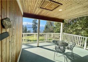 a patio with a table and chairs on a deck at Quarrystone House B&B in Fernwood +23 photos