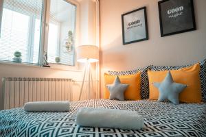 een slaapkamer met een bed met oranje en witte kussens bij NOA Luxury Apartment in Bitola