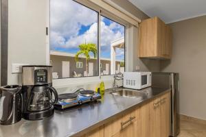 a kitchen with a counter top with a window at Piece of Paradise in Palm-Eagle Beach