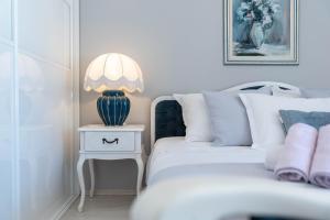 a bedroom with a bed and a side table with a lamp at Apartment Rosana - ZF Hvar in Hvar