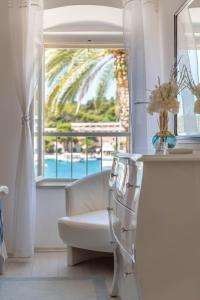 a living room with a white chair and a window at Apartment Rosana - ZF Hvar in Hvar
