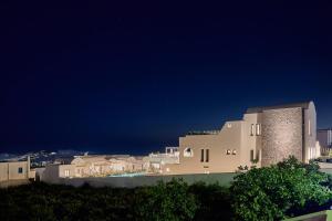 a group of buildings at night with the sky at Alleys All-Suite Hotel & Spa in Pirgos