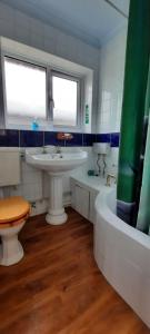 a bathroom with a sink and a toilet and a tub at Shirls chalet in Sheppey, Leysdown in Leysdown-on-Sea