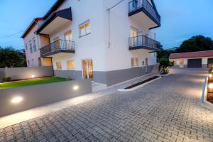 a large white apartment building with a driveway at Modern Apartment With Garden in Fátima